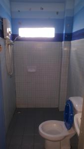 a small bathroom with a toilet and a shower at Mr. Clean Guesthouse in Krabi town