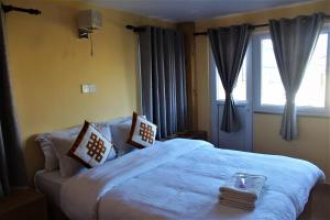 Una cama o camas en una habitación de Kiwi Backpackers Hostel Pokhara
