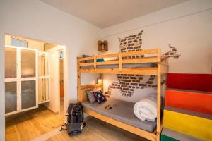 a room with two bunk beds in a room at Zostel Plus Mussoorie- Kempty in Mussoorie