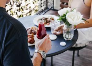 a man sitting at a table with a plate of food at The Lurline Randwick in Sydney