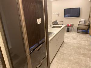 a kitchen with a refrigerator and a sink at My DearⅡ in Osaka