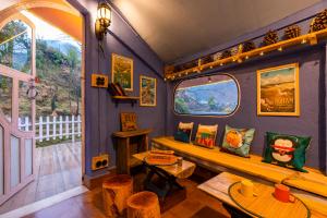 a living room with a bench and a window at Zostel Plus Mussoorie- Kempty in Mussoorie