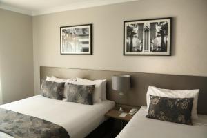 A bed or beds in a room at The Lurline Randwick