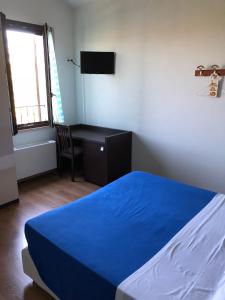 a bedroom with a blue bed and a desk at Agriturismo Pomod’oro in Torre San Patrizio