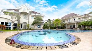 a large swimming pool in front of a building at Novilla Boutique Resort in Sungailiat