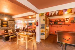 a living room with a ping pong table at Zostel Plus Mussoorie- Kempty in Mussoorie