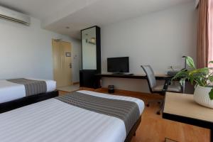 Postel nebo postele na pokoji v ubytování Paseo Premiere Hotel + 30 fotografií