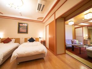 Postel nebo postele na pokoji v ubytování Iwakuni Kokusai Kanko Hotel