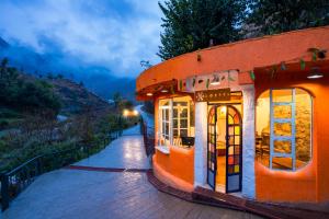 a building with windows on the side of a street at Zostel Plus Mussoorie- Kempty in Mussoorie