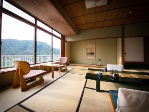 a living room with a view of a mountain at Iwakuni Kokusai Kanko Hotel in Iwakuni