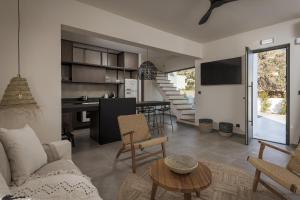 a living room with a couch and a table at Bianco Villa - Eve in Pefki Rhodes
