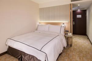 Postel nebo postele na pokoji v ubytování K Hotel Tianjin