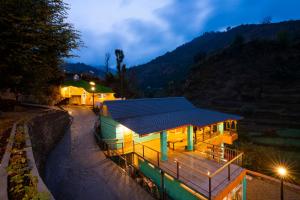 a house with a solar roof on top of it at Zostel Plus Mussoorie- Kempty in Mussoorie