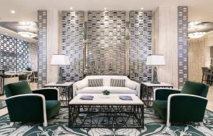 a lobby with a couch and two chairs and a table at Divani Palace Acropolis in Athens
