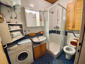 a bathroom with a washing machine and a sink at Apartma Snežinka in Kranjska Gora +14 photos
