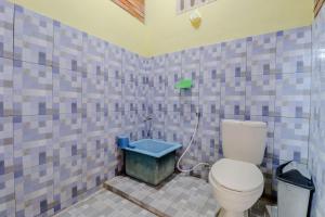 y baño con aseo y bañera. en Penginapan Barokah, en Kemadang