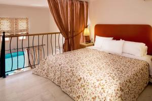 A bed or beds in a room at Mitsis Family Village