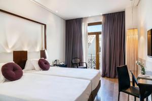 Posteľ alebo postele v izbe v ubytovaní Vincci Palace