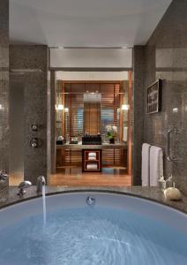 a bath room with a tub and a sink at Mandarin Oriental Tokyo in Tokyo