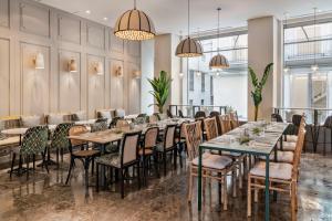 a dining room with tables and chairs and chandeliers at Vincci Palace in Valencia