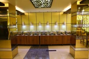 a bathroom with a row of sinks and mirrors at Tiger Garden Int Hotel in Khulna