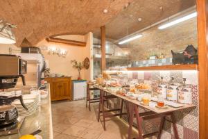 a kitchen with a long table with food on it at Palazzo Pacini in Colle di Val d'Elsa