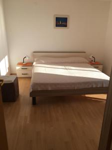a bedroom with a large bed and two night stands at Apartment Banko in Umag