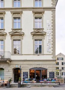 a building with a sign on the front of it at Design Hotel Plattenhof in Zürich