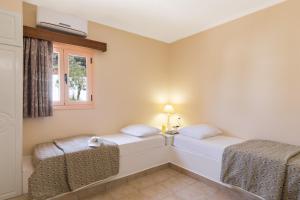A bed or beds in a room at Mitsis Family Village