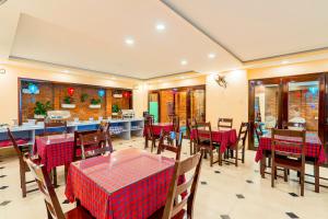 a restaurant with tables and chairs in a room at Golden River Hotel in Hoi An