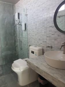 a bathroom with a toilet and a sink and a shower at Mon-Dee minihotel in Nan