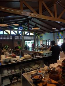 a group of people in a kitchen preparing food at Mon-Dee minihotel in Nan