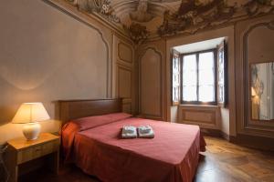 a bedroom with a bed with two shoes on it at Casa REGINA MONTIS REGALIS in Vicoforte