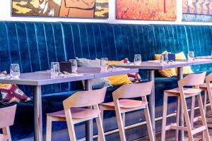 a row of tables and chairs in a restaurant at Comfort Hotel LT - Rock 'n' Roll Vilnius in Vilnius