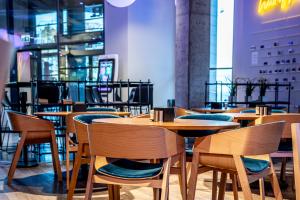 a dining room with wooden tables and chairs at Comfort Hotel LT - Rock 'n' Roll Vilnius in Vilnius