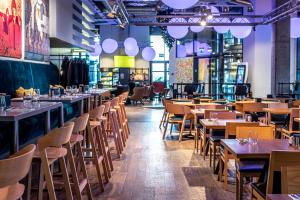 a restaurant with wooden tables and chairs at Comfort Hotel LT - Rock 'n' Roll Vilnius in Vilnius