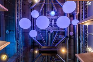 a room with white orbs hanging from the ceiling at Comfort Hotel LT - Rock 'n' Roll Vilnius in Vilnius