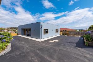 a large white building with a parking lot at Southern Apartments Launceston in Launceston