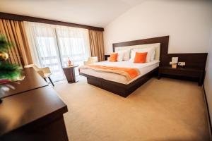 a hotel room with a bed and a large window at Hotel La Dolce Vita in Zărneşti +42 photos