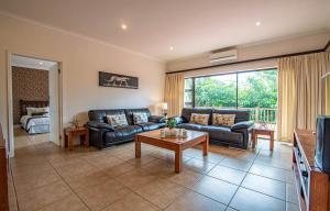 a living room with a couch and a table at Turnberry House T16 - Selborne Golf Estate in Pennington