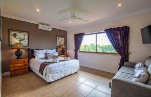 a bedroom with a bed and a couch and a window at Turnberry House T16 - Selborne Golf Estate in Pennington