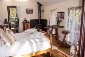 a bedroom with a bed and a wood stove at Finest Retreats - The Tree House - Eco-Friendly, Back to Nature Experience in Germansweek