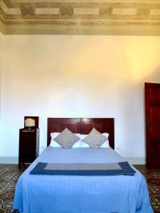 a bedroom with a bed with a blue comforter at Villa Anna in Torre del Lago Puccini