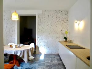 a kitchen with a white table and a white brick wall at Villa Anna in Torre del Lago Puccini