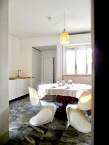 a white room with a table and chairs at Villa Anna in Torre del Lago Puccini +23 photos