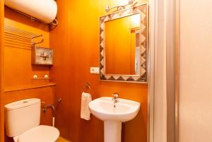 a bathroom with a white toilet and a sink at Canovas Nerja - Balcón de Europa in Nerja +24 photos