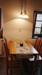 a wooden table with a bowl on top of it at Ferienhaus "Spatzennest" Eifel Gerolstein Hunde ok in Oberbettingen