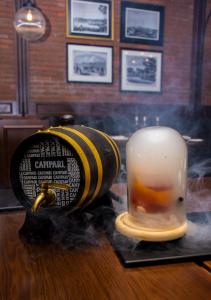 a drink in a glass jar sitting on a table at The Kingsbury Colombo in Colombo +82 photos