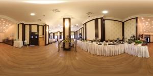 a banquet hall with tables with white table cloths at Sapci Prestige Hotel in Kesan