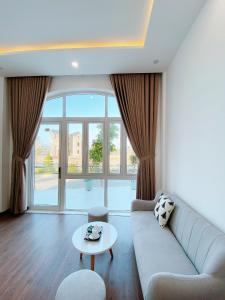 a living room with a couch and a table at THE VILLA HIEU HY in Quy Nhon